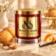 MAISON NOOR Amaretto Madeleine red glass candle with gold lid, styled with madeleines, almonds, orange peel, vanilla and oats.