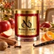 MAISON NOOR Apple Harvest red glass candle with gold lid, styled with apples, cinnamon, nutmeg, cloves, orange peel and vanilla in warm autumn light.