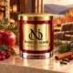 MAISON NOOR Autumn Glow red glass candle with gold lid, styled with apple, cranberry, juniper, pine, cinnamon and cloves in a warm luxury lodge.