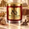 MAISON NOOR Baking Spices Element red glass candle with gold lid, styled with nutmeg, cloves and allspice on pale limestone in warm light.