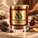 MAISON NOOR Black Cardamom and Cream red glass candle with gold lid, styled with black cardamom, cinnamon, peppercorns, ginger, chestnut and warm wood.