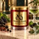 MAISON NOOR Black Currant Absinthe red glass candle with gold lid, styled with black currants, blackberries, star anise, basil, eucalyptus and an absinthe glass.