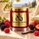 MAISON NOOR Black Raspberry Vanilla red glass candle with gold lid, styled with dark and red raspberries, cherry, strawberry, plum and vanilla on ivory stone.