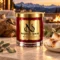 MAISON NOOR Campfire Marshmallow red glass candle with gold lid, styled with toasted marshmallows, eucalyptus and oak on a luxury lodge terrace at dusk.