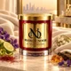 MAISON NOOR Cashmere Musk red glass candle with gold lid, styled with cream cashmere, violets, lily of the valley, bergamot, saffron and amber.