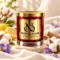 MAISON NOOR Clean Cotton candle in red glass with gold lid, styled with cotton blossoms, linen, lemon and violets.