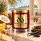MAISON NOOR Coconut Soleil red glass candle with gold lid, styled with coconut, pineapple, banana, vanilla and tonka beans beside a tropical lagoon.