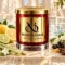 Red MAISON NOOR candle with gold lid beside lemon, lime, lemongrass, jasmine and black currants in a bright spa setting.