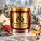 Red MAISON NOOR candle with gold lid beside frosted evergreen foliage, pear, red currants, sage, cherry blossom and citrus peel.