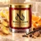 Red MAISON NOOR candle with gold lid beside ginger, citrus, sugar, vanilla, cinnamon, cloves, nutmeg and allspice.