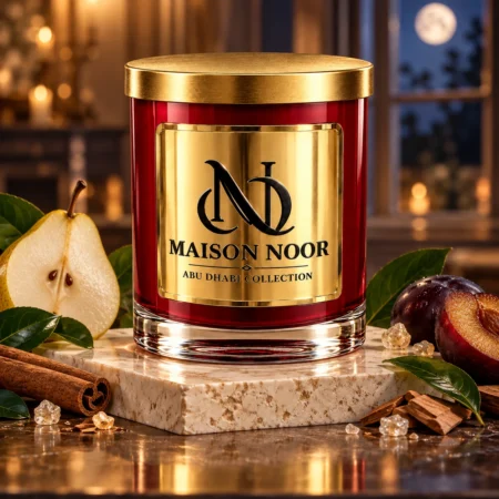 Red MAISON NOOR candle with gold lid beside pear, plum, cinnamon, green leaves, sugar crystals and sandalwood in a moonlit salon.