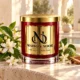 MAISON NOOR Orange Blossom candle with white citrus blossoms, jasmine, bergamot and sandalwood on a sunlit ivory stone courtyard ledge.